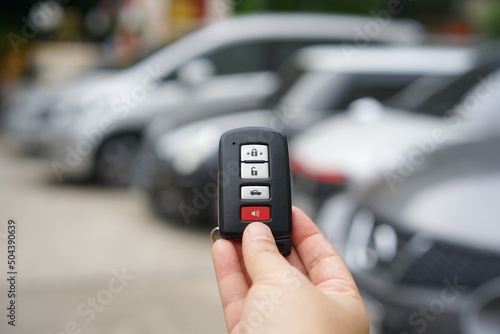 Black car remote key There is a small loop hanging on it and there are 3 gray buttons for locking and unlocking the car, 1 red button for horn (Use in Emergencies). smart key system for modern cars. 