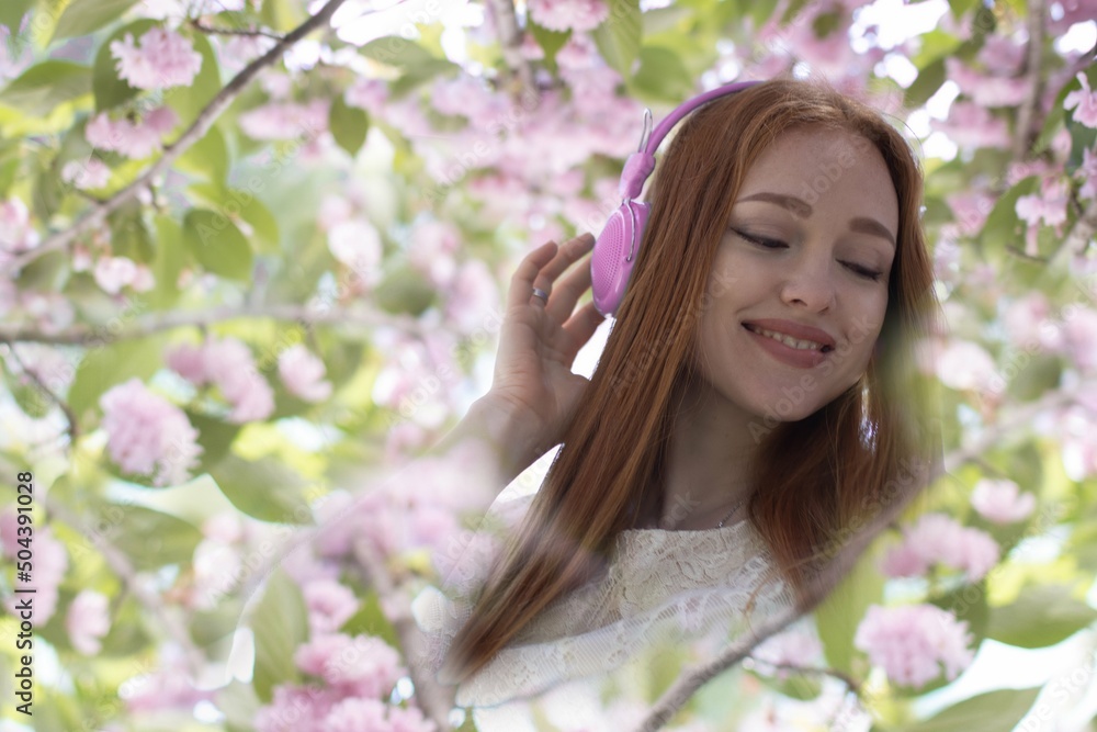 beautiful girl with headphones among sakura flowers, background
beautiful girl with headphones among sakura flowers, background