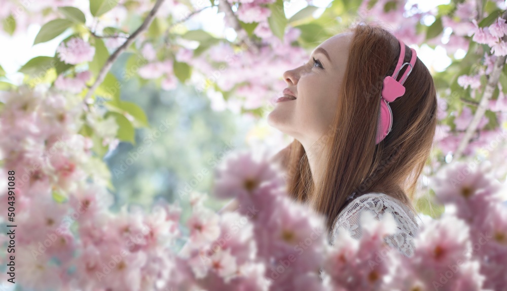 beautiful girl with headphones among sakura flowers, background
beautiful girl with headphones among sakura flowers, background