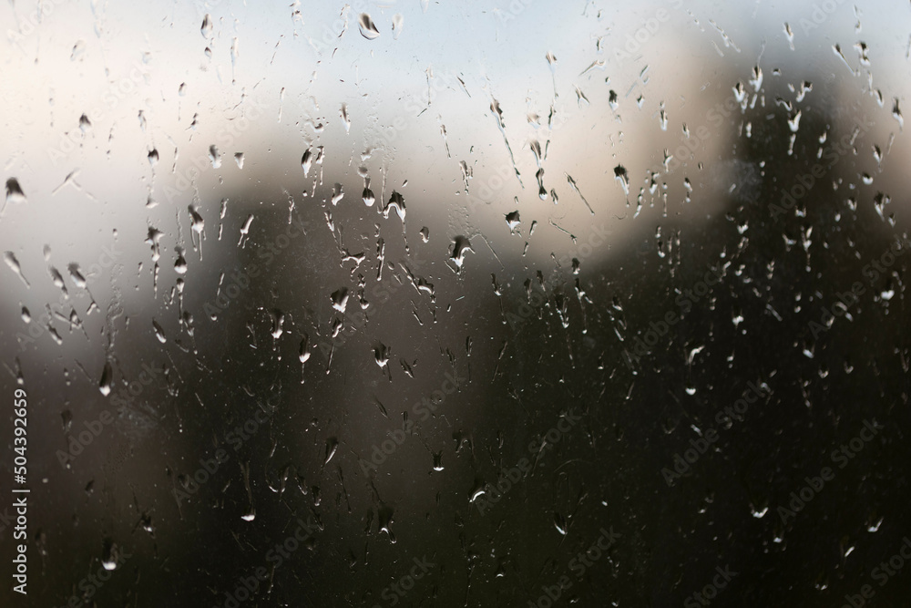 Raindrops on window glass, abstract background, rainy weather