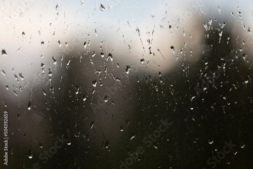 Raindrops on window glass, abstract background, rainy weather