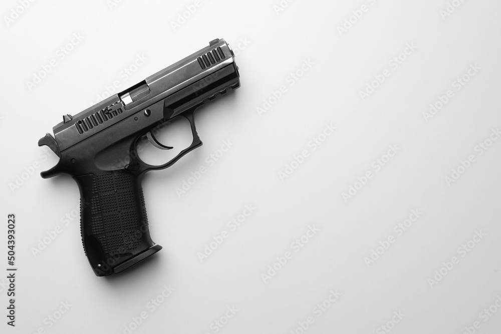 Semi-automatic pistol on white background, top view. Space for text Semi-automatic pistol on white background, top view. Space for text