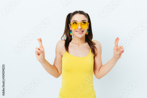 Excited young woman wearing summer yellow sunglasses