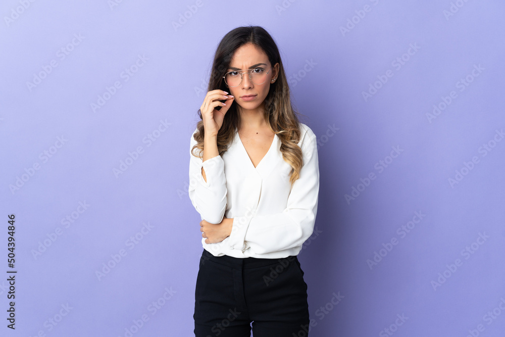 Young caucasian woman isolated on purple background showing a sign of silence gesture Young caucasian woman isolated on purple background showing a sign of silence gesture