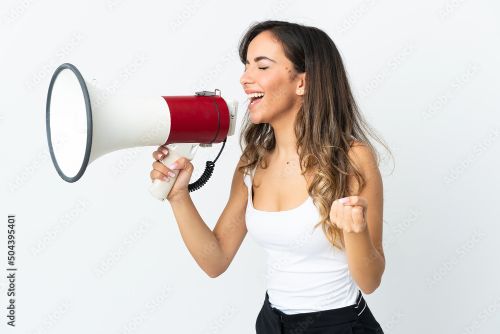 Young caucasian woman isolated on white background shouting through a megaphone to announce something in lateral position Young caucasian woman isolated on white background shouting through a megaphone to announce something in lateral position