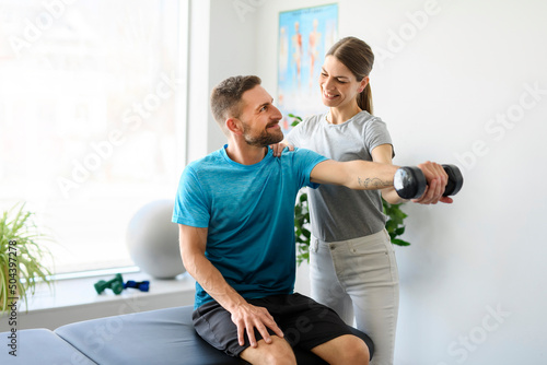 Modern rehabilitation physiotherapy woman worker with man client