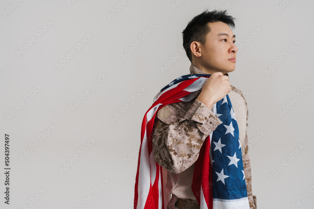Asian military man wearing uniform posing with american flag Asian military man wearing uniform posing with american flag