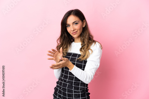 Young caucasian woman isolated on pink background applauding