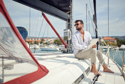 Spontaneous businessman working on the yacht