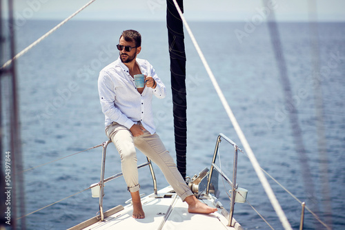 Casual attractive man sailing alone; Luxurious lifestyle concept