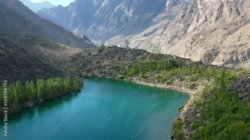 aerial drone of a unique glacier blue lake called Upper Kachura Lake, surrounded by a green forest in the mountains of Skardu Pakistan on a sunny summer day aerial drone of a unique glacier blue lake called Upper Kachura Lake, surrounded by a green forest in the mountains of Skardu Pakistan on a sunny summer day