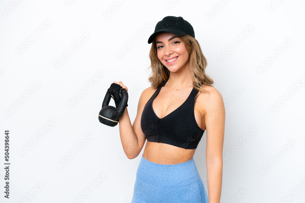 Young caucasian woman isolated on white background making weightlifting with kettlebell Young caucasian woman isolated on white background making weightlifting with kettlebell