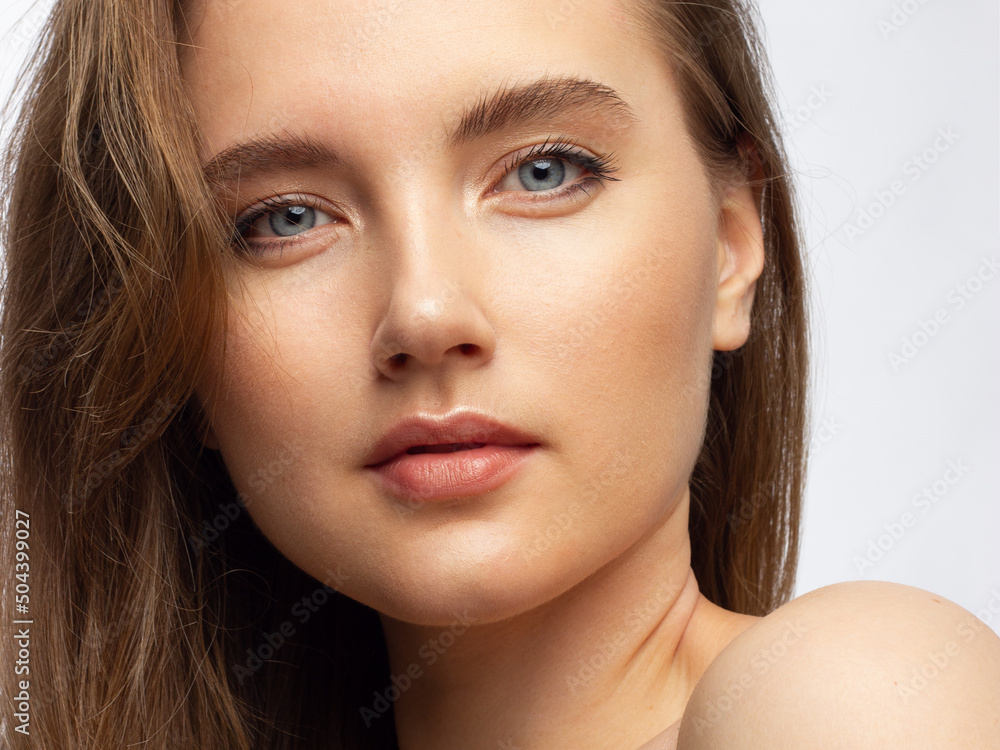 Fototapeta premium Closeup of beauty woman with clean shiny skin and natural cosmetics. Beautiful extrem eyelash and plump lips of a well-groomed girl demonstrate spa procedures, injections in a beauty parlor