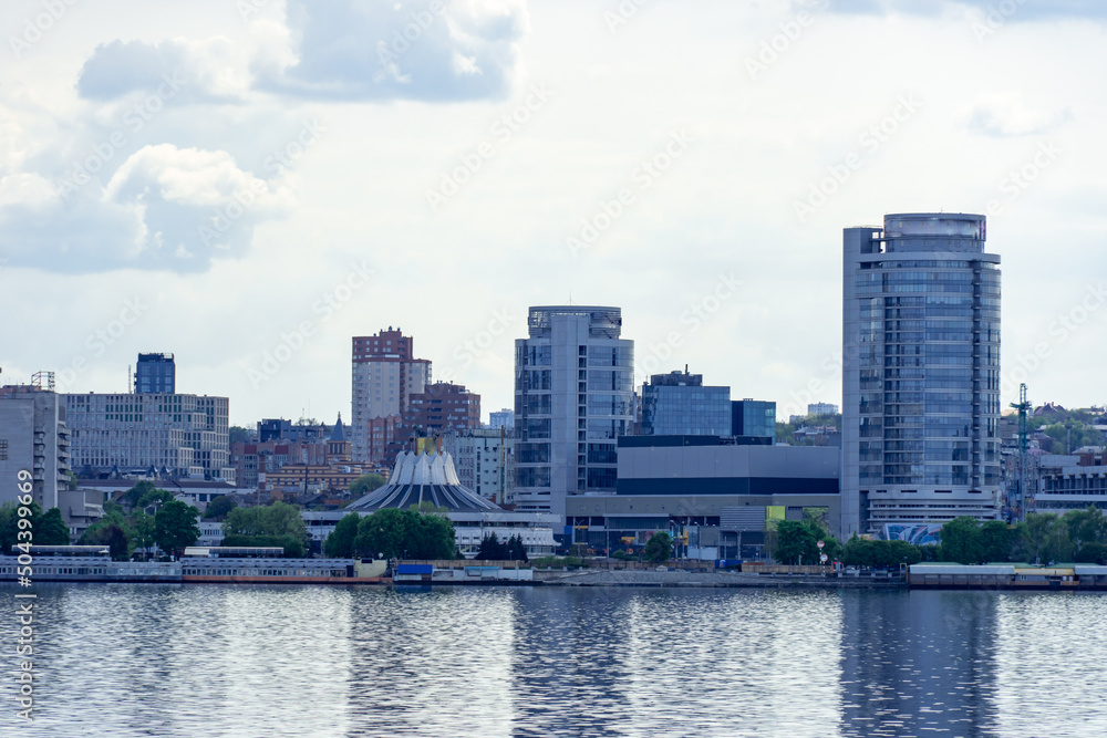 Panoramic view on the central part Dnipro city and river bank in the Ukraine. Urban landscape with shopping centers, business offices and high-rise apartments. Beautiful embankment against the sky. Panoramic view on the central part Dnipro city and river bank in the Ukraine. Urban landscape with shopping centers, business offices and high-rise apartments. Beautiful embankment against the sky.
