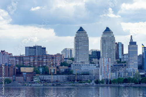 Panoramic view on the central part Dnipro city and river bank in the Ukraine. Urban landscape with shopping centers, business offices and high-rise apartments. Beautiful embankment against the sky.  photo
