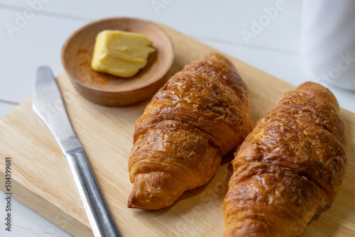 Close up of Croissants Served With Butter and Coffee on Table in Restaurant for Breakfast