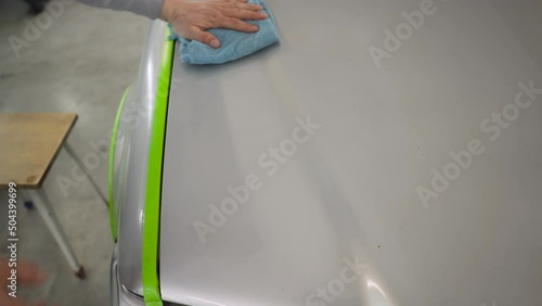 Wallpaper Mural A professional car wash employee polishes the hood of a gray car. Close-up of the hand of the washer wipes the car. Detailing car. Torontodigital.ca