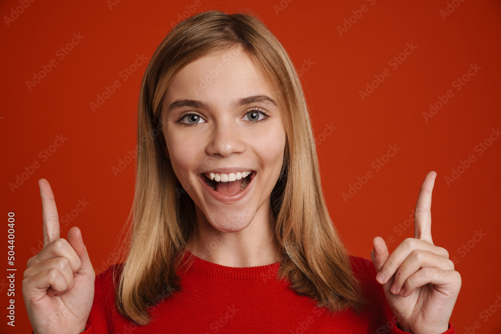 Blonde white girl smiling while pointing fingers upward Blonde white girl smiling while pointing fingers upward