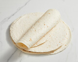 Plain tortilla wrap on white background from above.