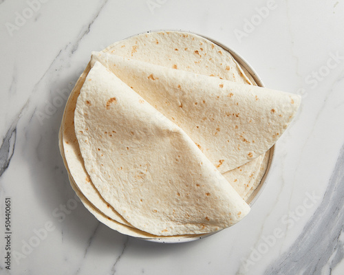Plain tortilla wrap on white background from above. photo