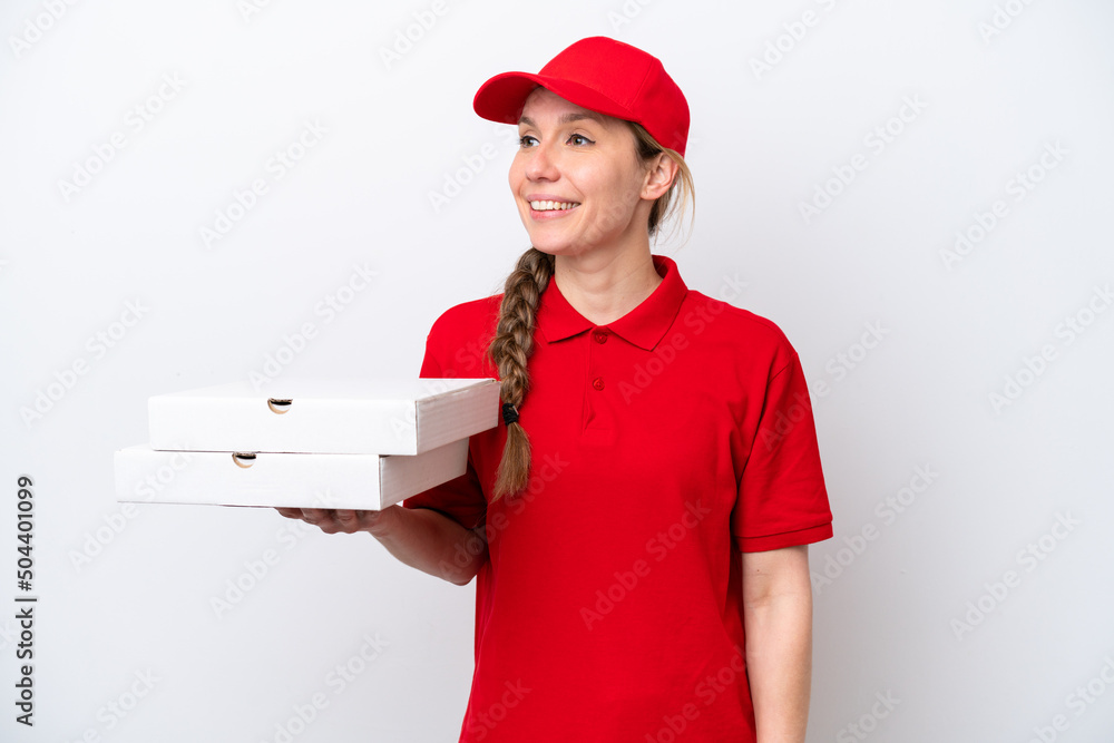 pizza delivery woman with work uniform picking up pizza boxes isolated on white background looking to the side and smiling pizza delivery woman with work uniform picking up pizza boxes isolated on white background looking to the side and smiling