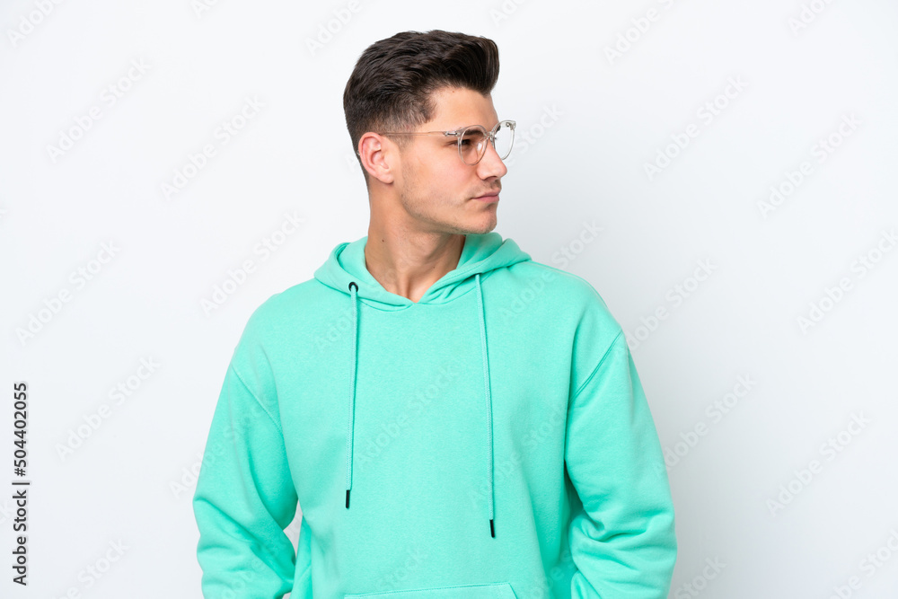 Young handsome caucasian man isolated on white bakcground looking to the side Young handsome caucasian man isolated on white bakcground looking to the side