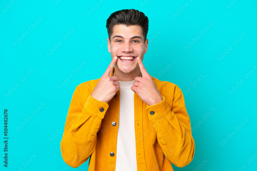 Young handsome caucasian man isolated on blue bakcground smiling with a happy and pleasant expression Young handsome caucasian man isolated on blue bakcground smiling with a happy and pleasant expression
