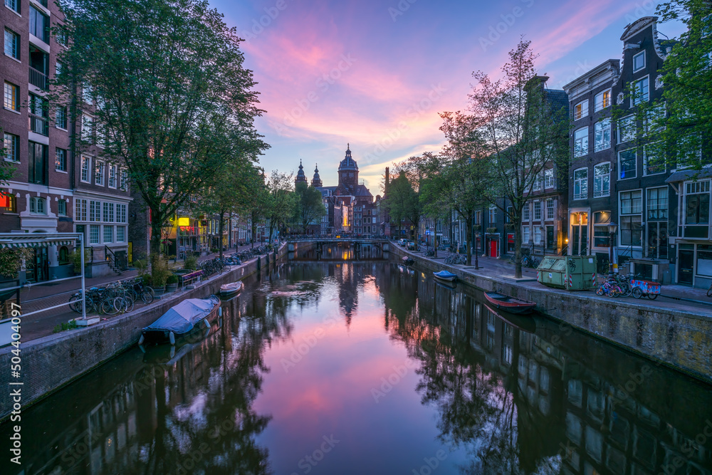 Oudezijds Voorburgwal street and Arm Bridge at sunrise, Amsterdam, Netherlands