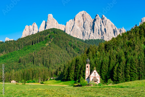 Church of St. John of Nepomuk in front of Odle mountain in Funes Valley of Dolomite South Tyrol Italy. View of San Giovanni Church or St. John's Church or St. Johann Church in village of Ranui Italy. photo