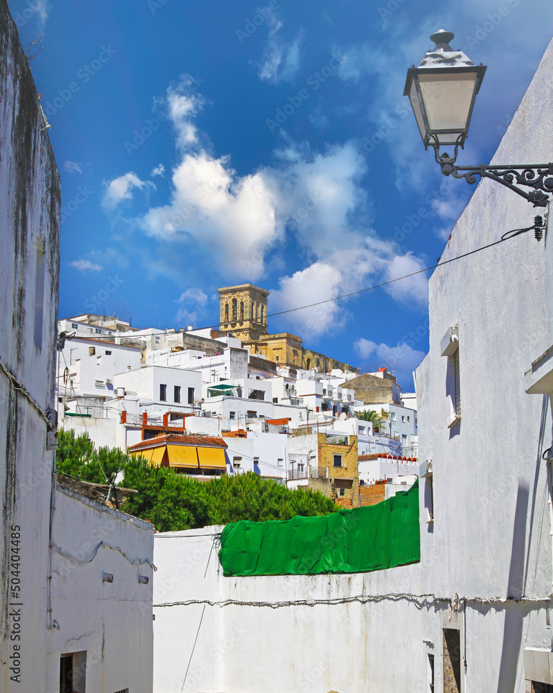Beautiful andalusian village with white houses, church tower, blue summer sky - Arcos de la frontera, Spain