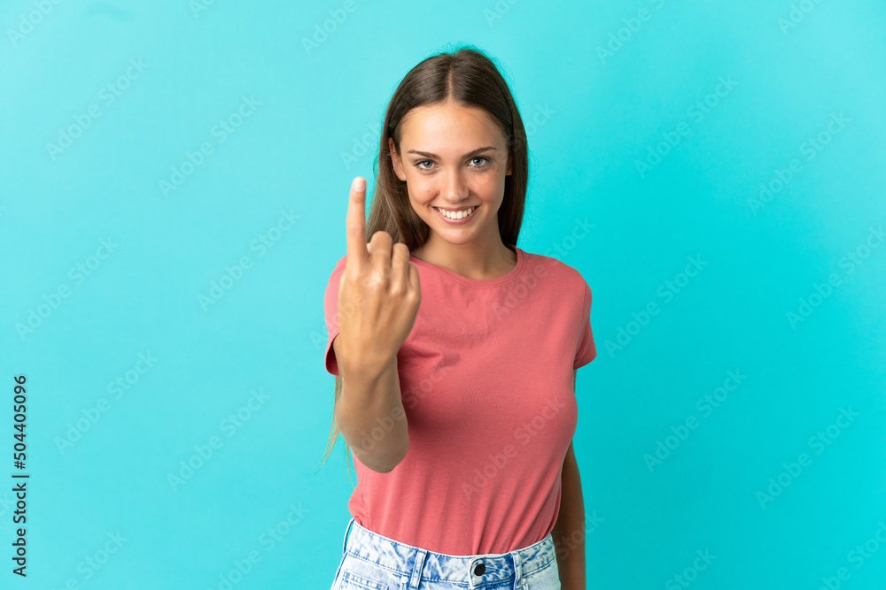 Young woman over isolated blue background doing coming gesture Young woman over isolated blue background doing coming gesture