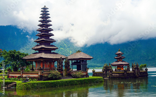Beautiful mystic moody spiritual landscape, lake island, old hindu temple, mountains, deep misty clouds - Pura Ulun Danu Batur Bratan - Bali