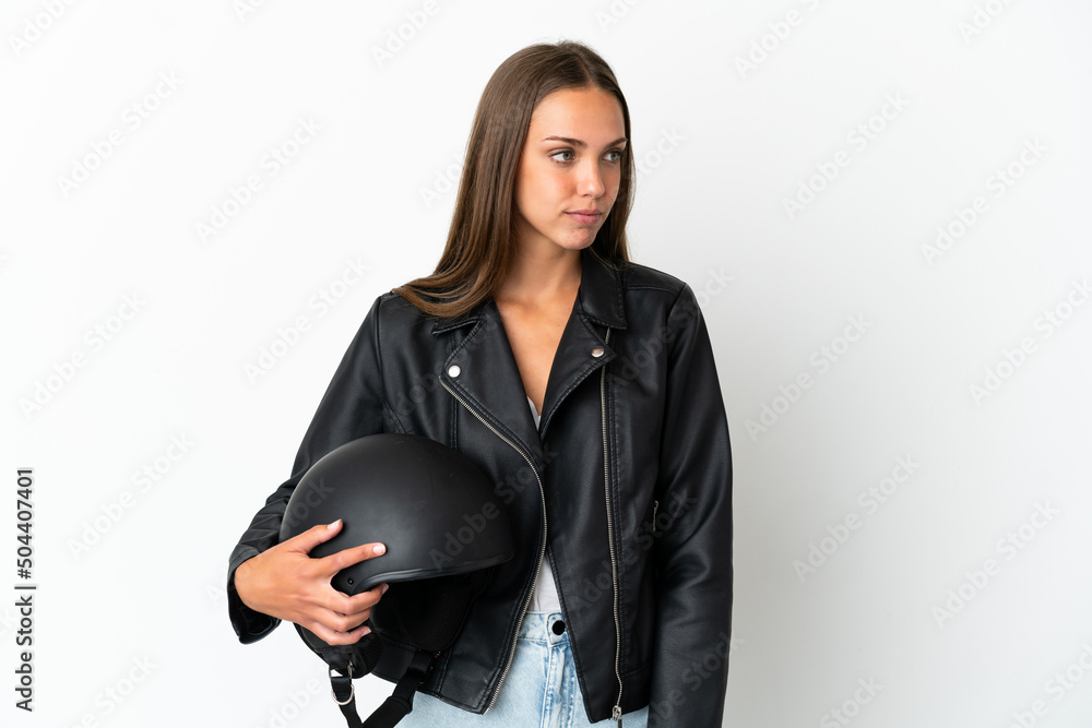 Woman with a motorcycle helmet over isolated white background looking to the side Woman with a motorcycle helmet over isolated white background looking to the side