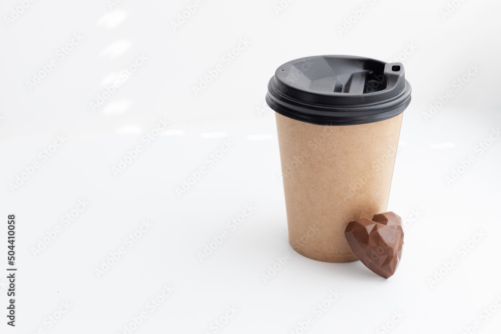 craft cup with chocolate candy on a light background craft cup with chocolate candy on a light background