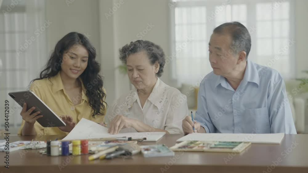 Artist concept of 4k Resolution. Asian families drawing together in the living room. Artist is creating work. Leisure activities and hobbies. Artist concept of 4k Resolution. Asian families drawing together in the living room. Artist is creating work. Leisure activities and hobbies.