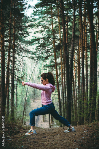 Woman practice Tai Chi Chuan in a park. Chinese management skill Qi's energy. solo outdoor activities.