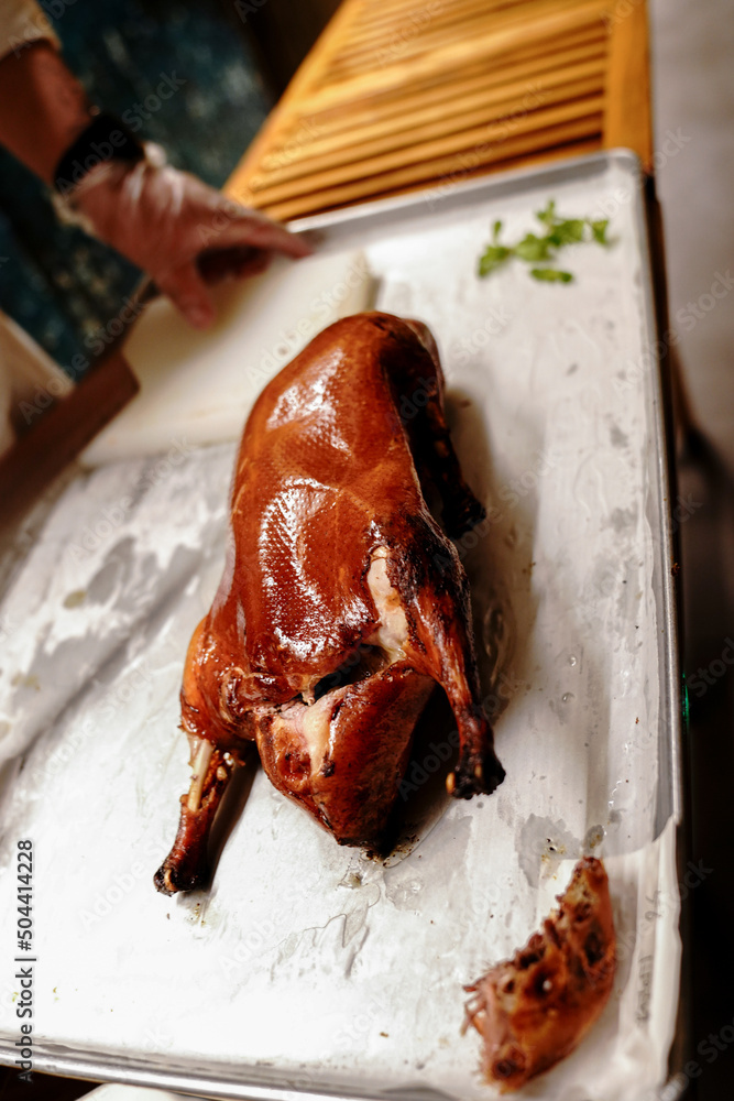 Chinese cook prepares Peking Roast Duck. Peking Duck is a famous duck