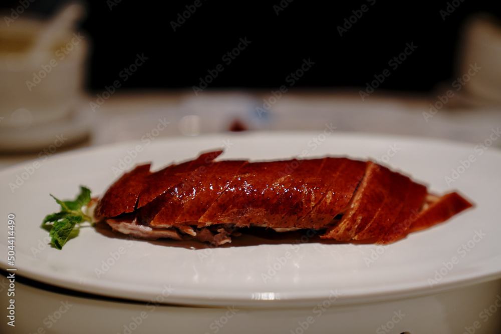 Chinese cook prepares Peking Roast Duck. Peking Duck is a famous duck dish from Beijing that has