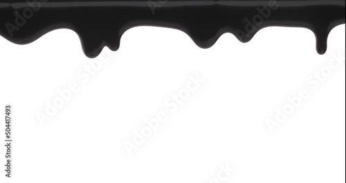 Black sticky liquid dripping down. Isolated on white background. photo