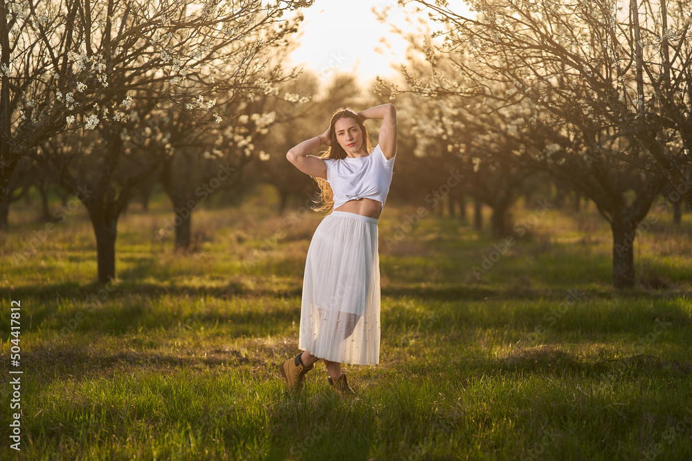 Beautiful woman in a plum orchard in bloom Beautiful woman in a plum orchard in bloom