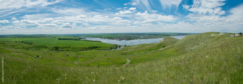 Sunny view on panorama of the Volga river. landscape with green hills, a clear summer sky and a river