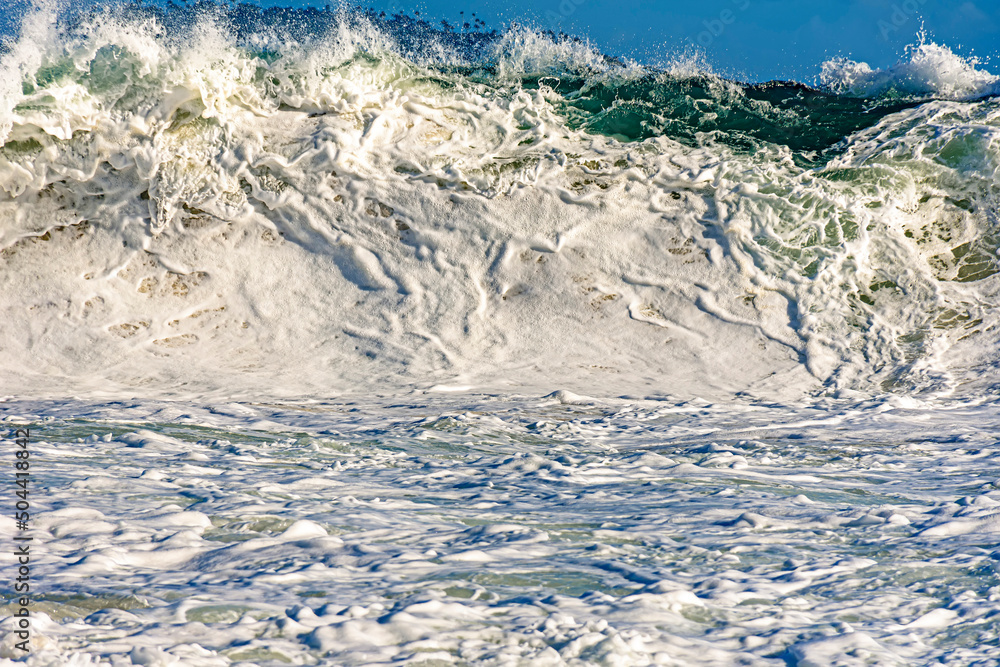 Strong wave and sea foam at Ipanema beach in Rio de Janeiro on a sunny day