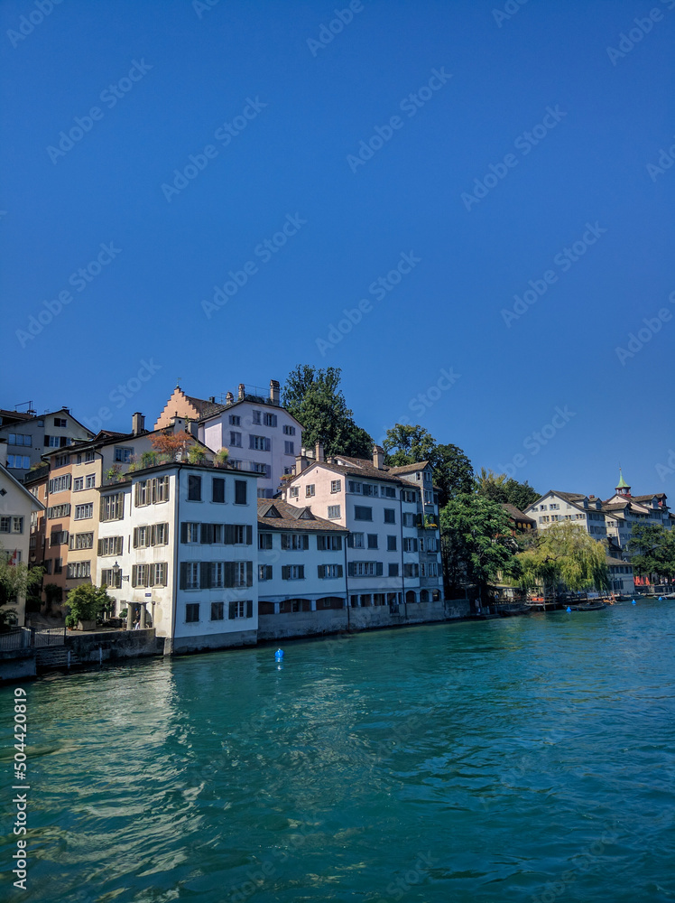 Zurich, Switzerland - August 18, 2019: Beautiful view of the architecture of the old city of Zurich against the blue sky. Vertical