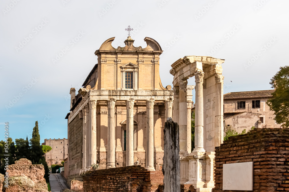 Obraz premium Panoramic close up view of the Antoninus and Faustina Temple in the Roman Forum (Foro Romano) in the city of Rome, Lazio, Italy, EU Europe. Ancient ruins of the Roman Temple on Via Sacra. Culture trip