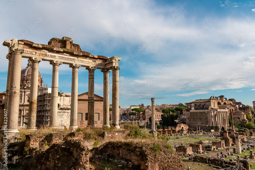 The columns of the Temple of Saturn and overview of the ancient ruins of the Roman Forum, UNESCO World Heritage Site, Rome, Lazio, Italy, Europe. Central Square area of the Roman Forum. Cityscape