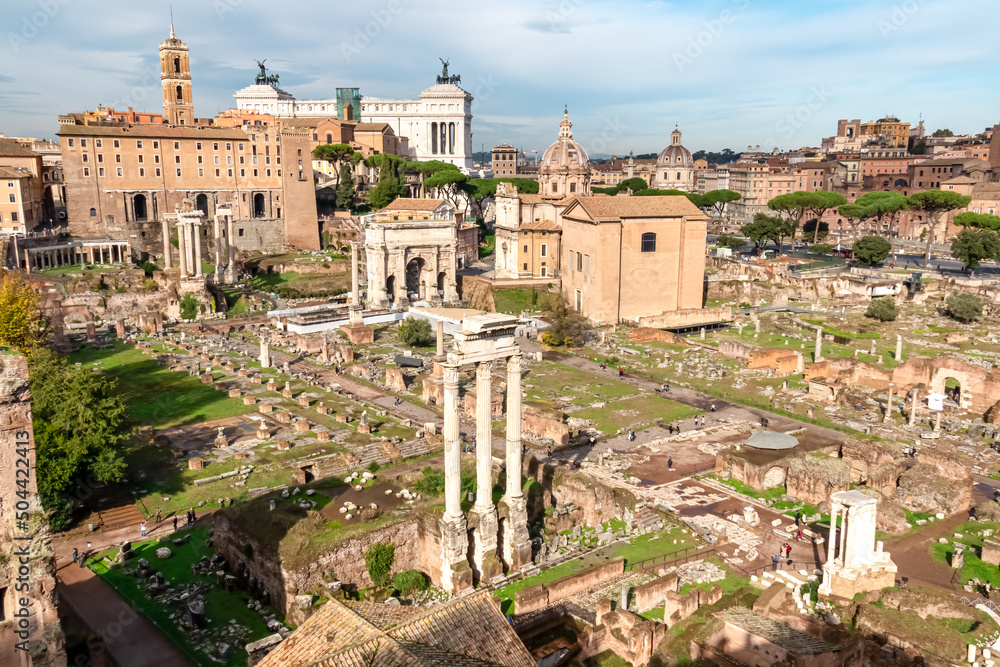 Panoramic view on ancient ruins of Roman Forum and Rome Skyline from Palatine Hill in city of Rome, Lazio, Italy, Europe, EU. Looking on Antoninus and Faustina Temple, Victor Emmanuel II monument