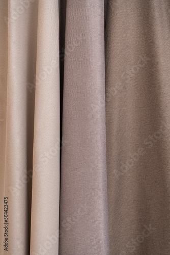 Folded fabric for curtains. Beige curtains.