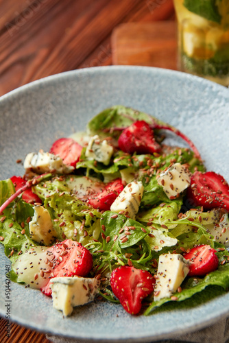 Bright salad with strawberry, spinach and blue cheese.