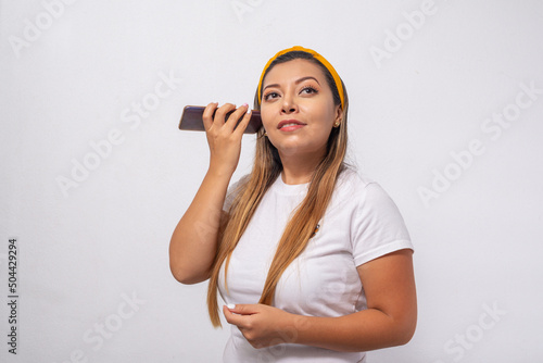 Portrait of a young woman listening to her cell phone.