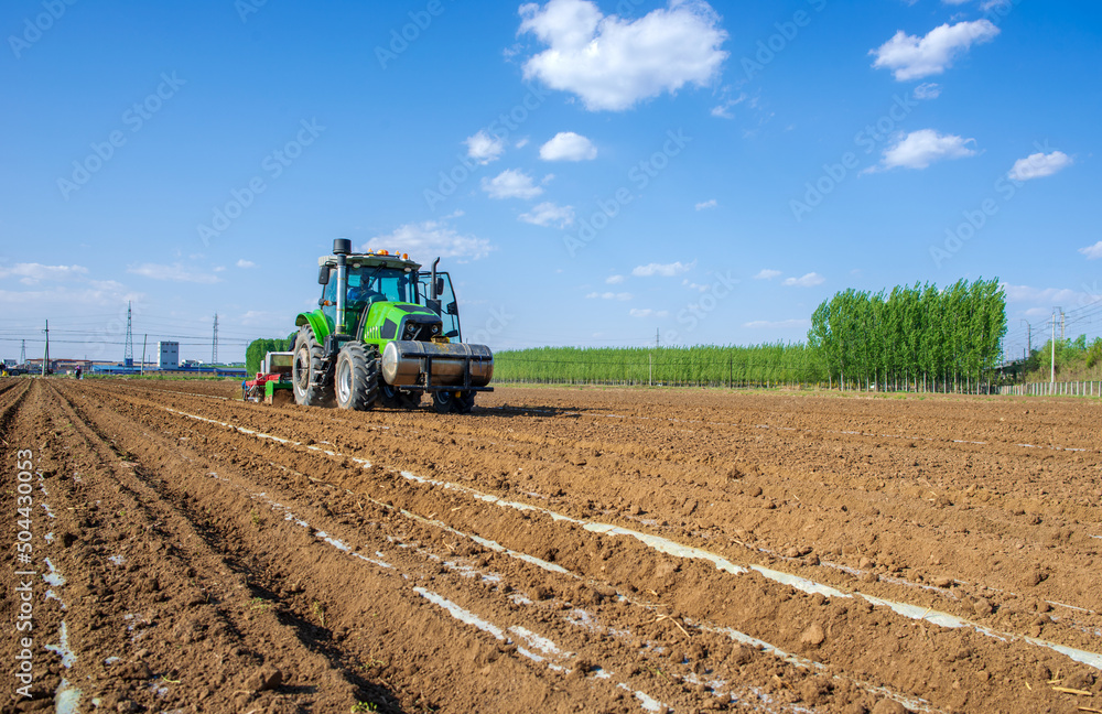 Fototapeta premium Mechanized agricultural sowing in spring